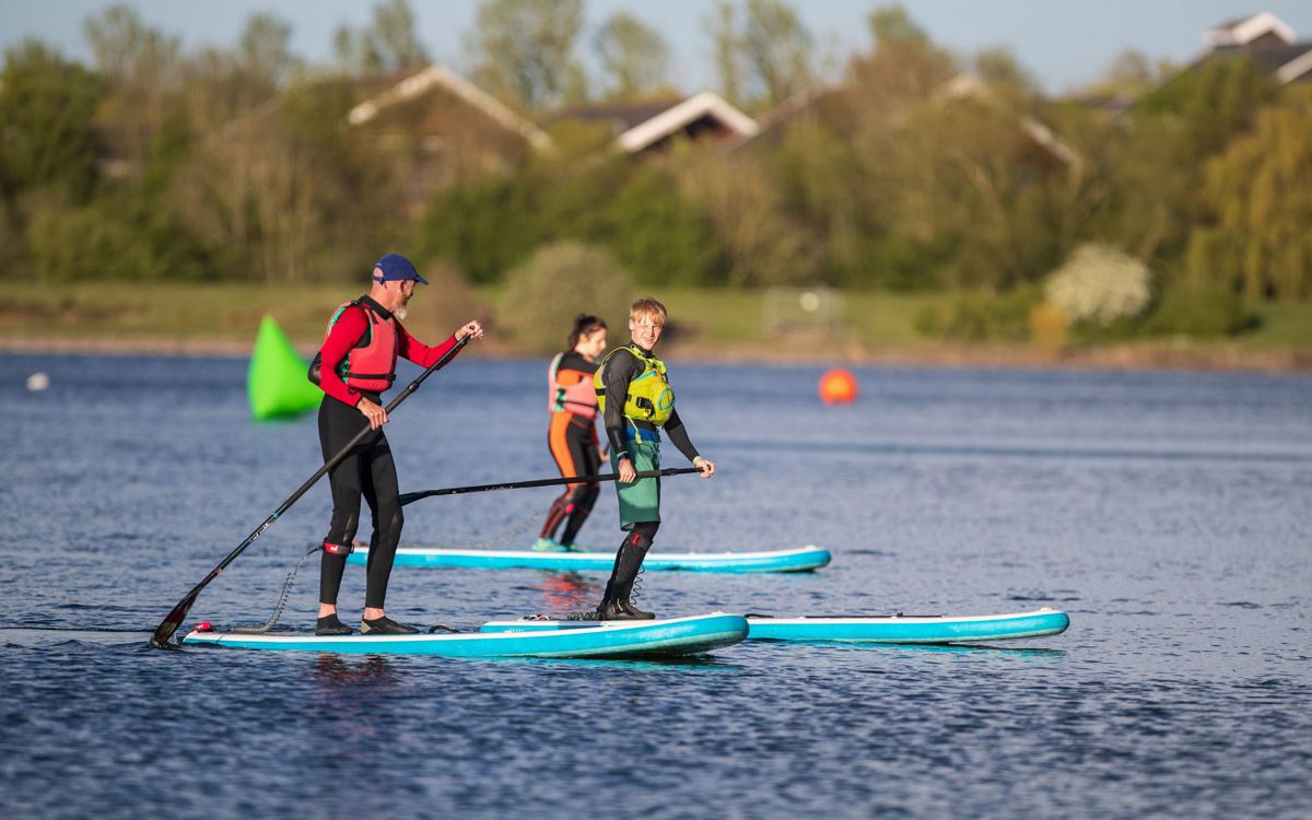 People paddleboarding on Willen Lake in Milton Keynes