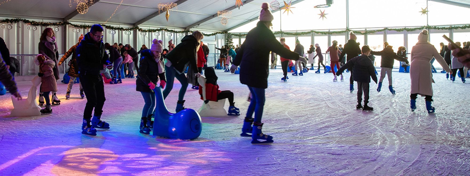 People ice skating on rink at Willen Lake in Milton Keynes