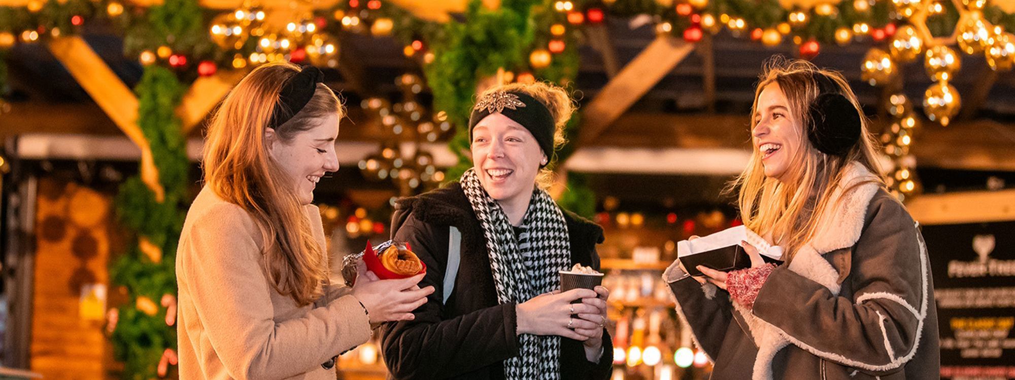 Ladies eating and laughing outside Apres Ski Bar at Willen On Ice