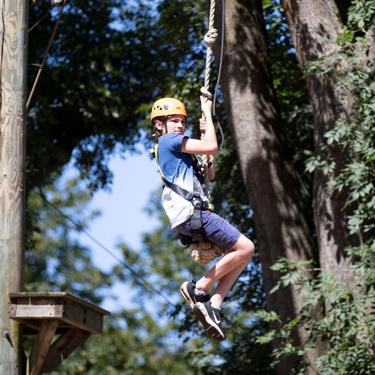 Child on zip wire on Treetop Adventure high ropes course at Willen Lake