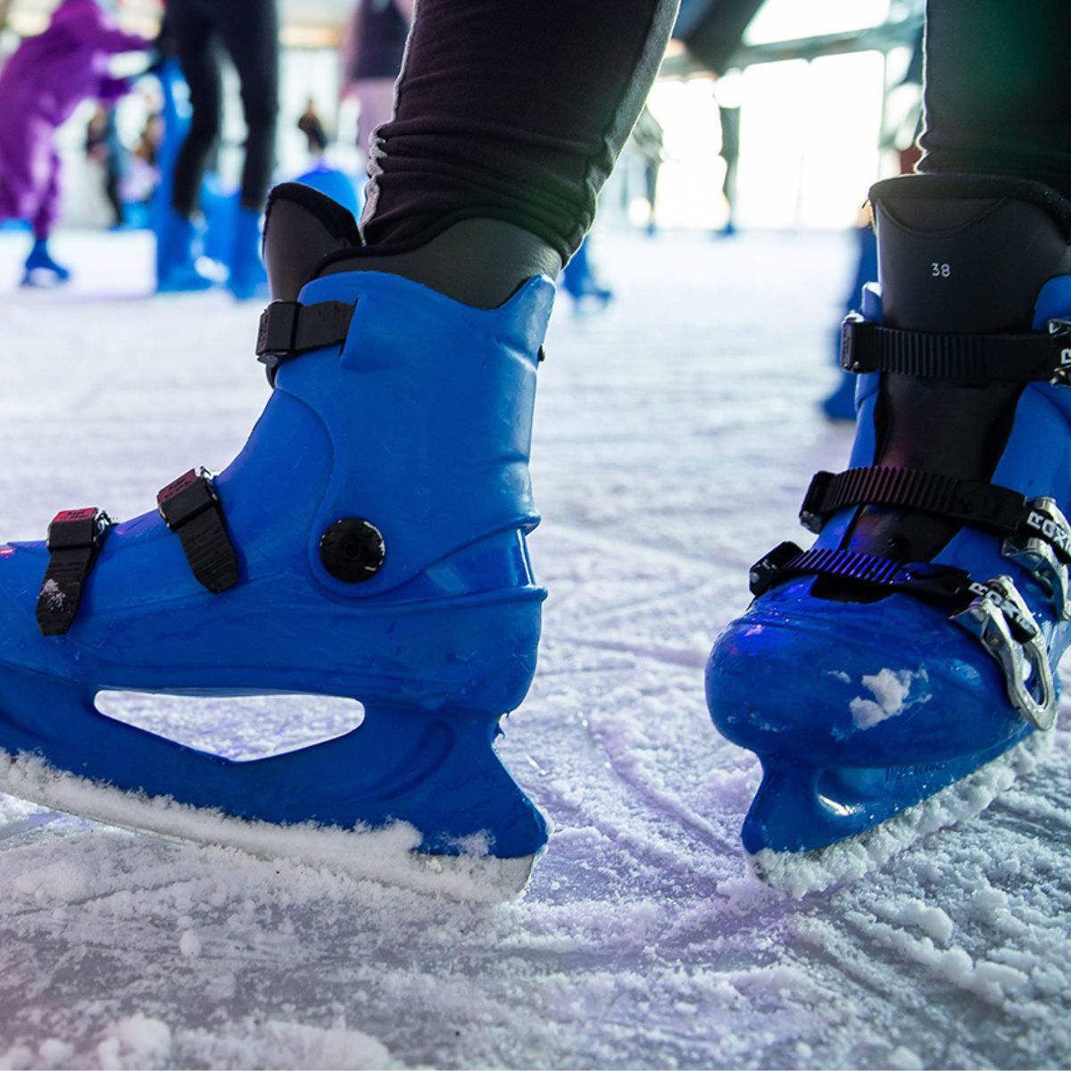 Blue ice skates on skating rink